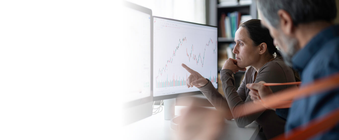 woman pointing at screen showing data visuals